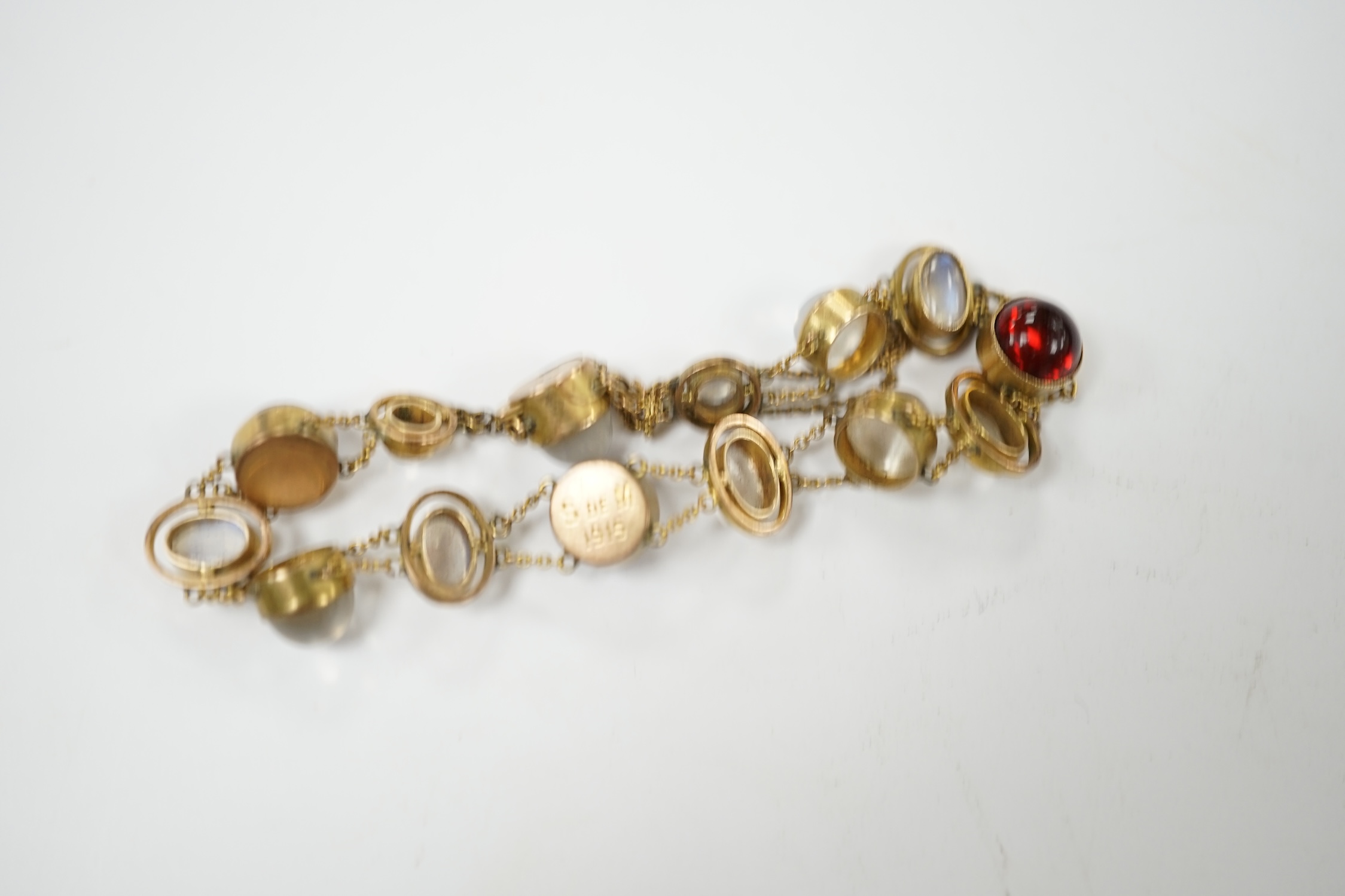 A George V 9ct, cabochon moonstone and cabochon red paste set bracelet, 16.5cm, gross weight 12 grams, Condition - fair